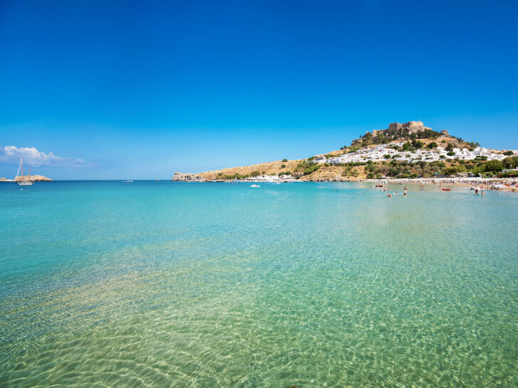 bright teal water best greek islands for honeymoon with view of coastline and beach
