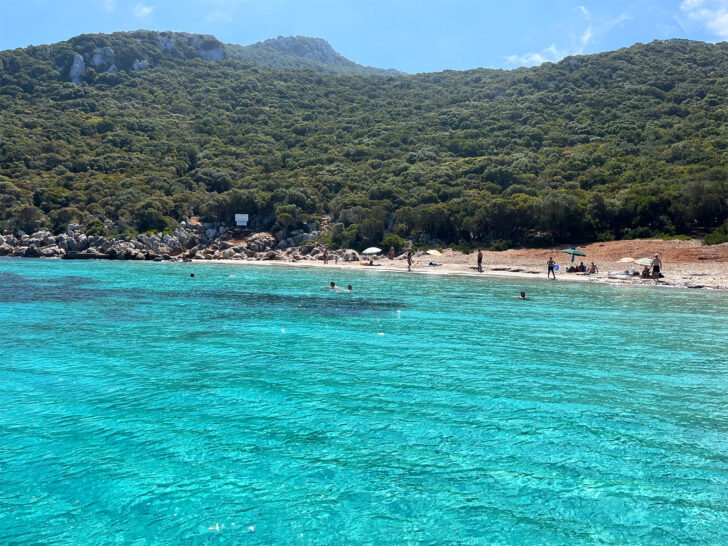 bright blue water at seashore along island in greece for couples to visit