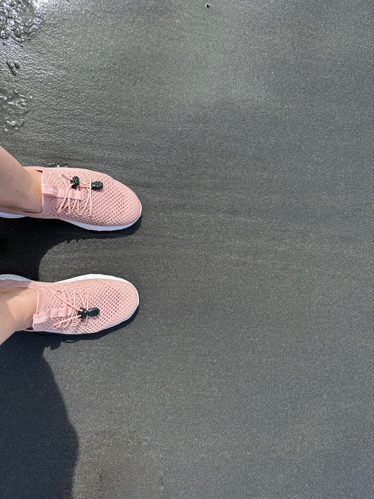 pink water shoes on black sand beach vieques or culebra