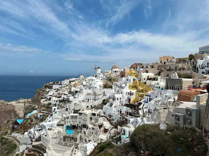 white and tan buildings on hillside in Santorini