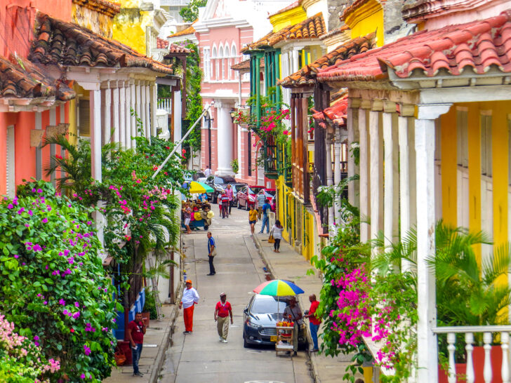 Cartagena Colombia with vibrant city street plenty of plants and people walking