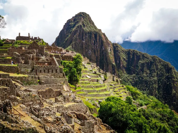 stone civilization on side of mountain in the clouds Machu Picchu Peru