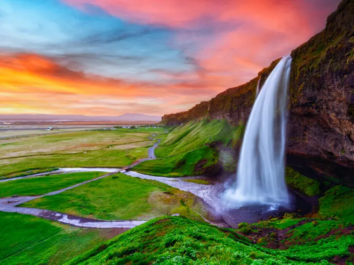 best 40th birthday trips Iceland waterfall with beautiful sunset