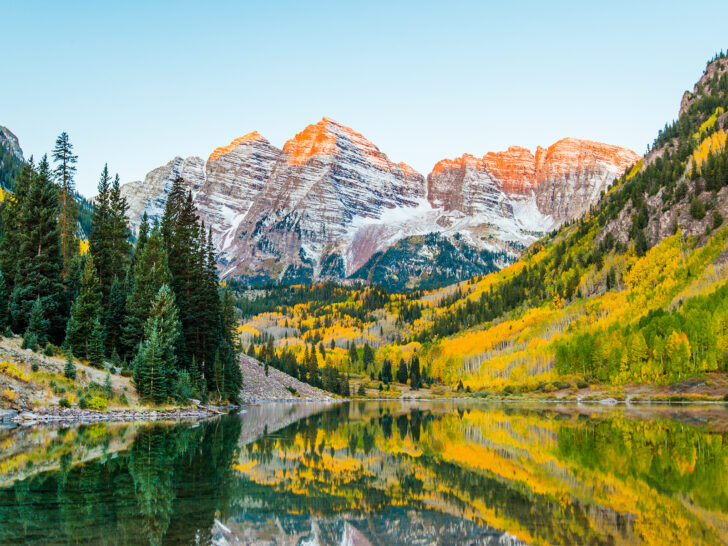 maroon bells colorado best places to visit in October USA view of mountains with bright yellow trees and lake reflection