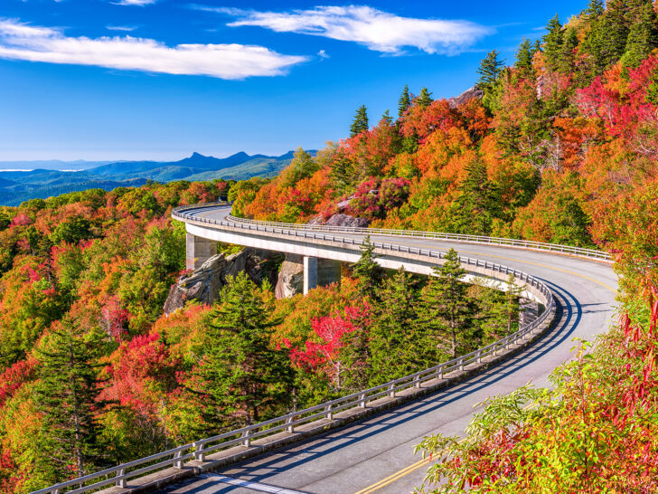 best places to visit in October USA winding road with bright red orange and green trees