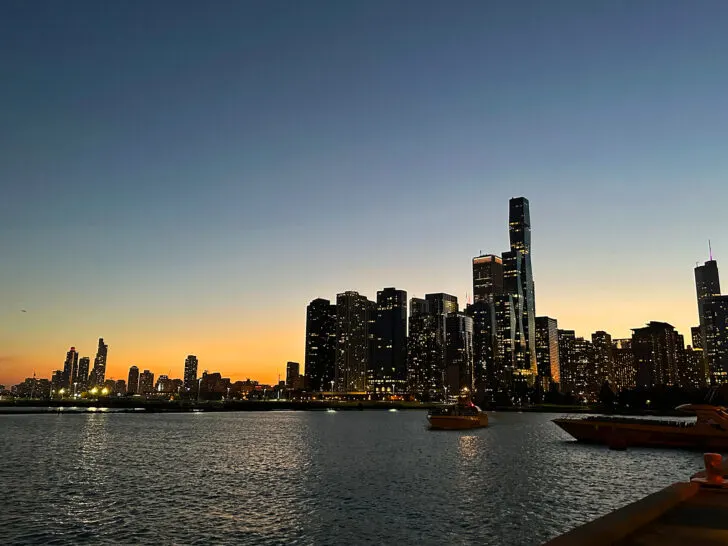 tall buildings Chicago skyline at night along Lake Michigan
