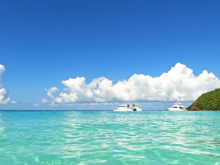 boats on water bright teal water puffy clouds in sky on ocean culebra or vieques