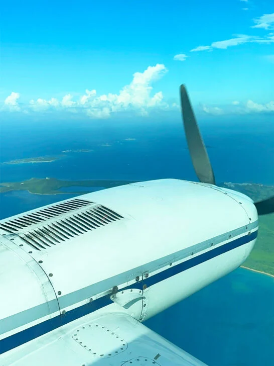 vieques or culebra view of airplane propeller with islands out window