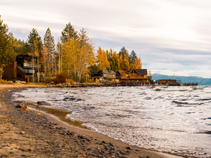 lakeshore with waves yellow and orange trees with large cabins best places to visit in October USA