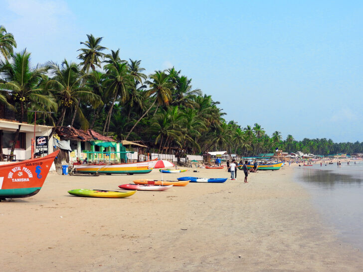 40th birthday destinations Goa India beach with multicolored kayaks and boats and palm trees