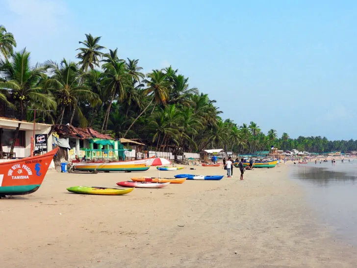 40th birthday destinations Goa India beach with multicolored kayaks and boats and palm trees