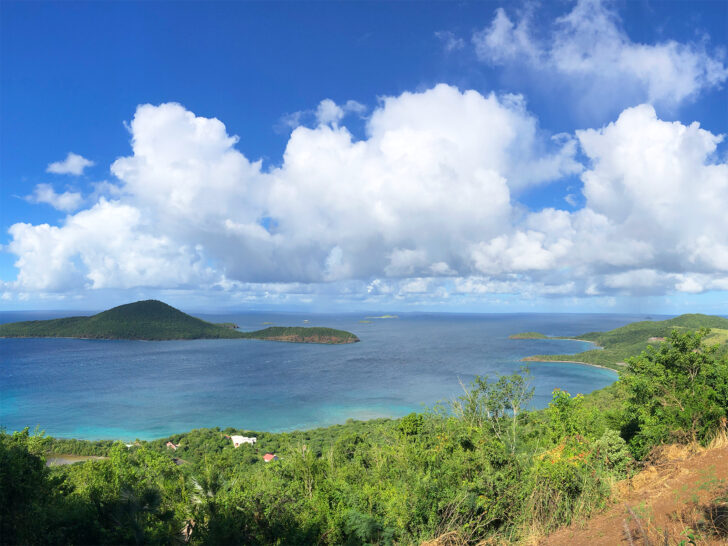 vieques or culebra view of ocean from atop island with white puffy clouds blue water lush foliage