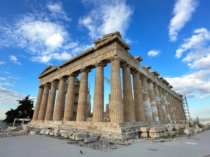 2 days in Athens view of Parthenon at the Acropolis with large stone columns archeological ruins on sunny day with a few clouds