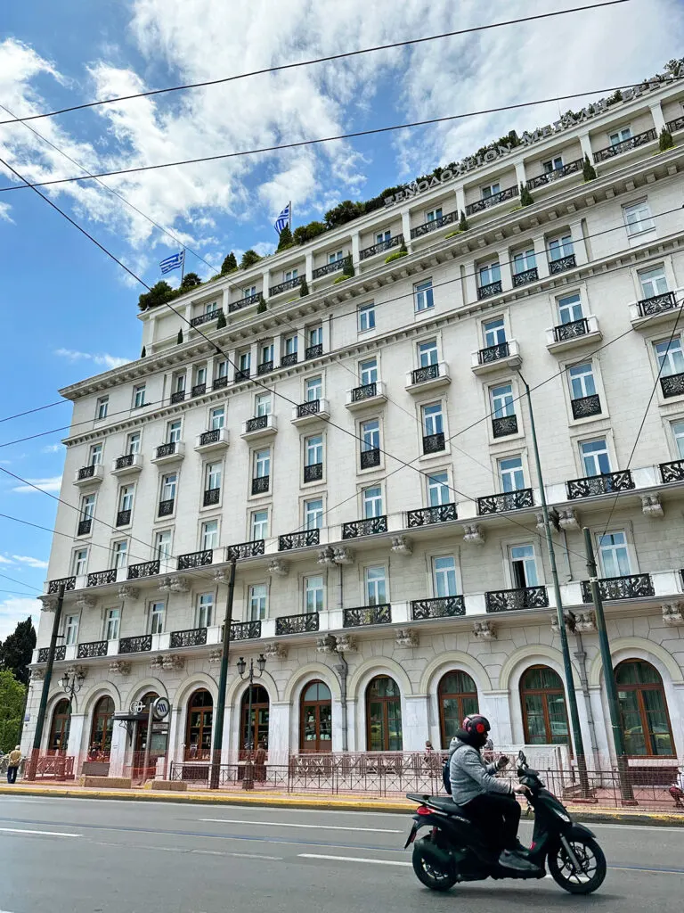 2 days in athens itinerary view of building with person riding moped on sunny day