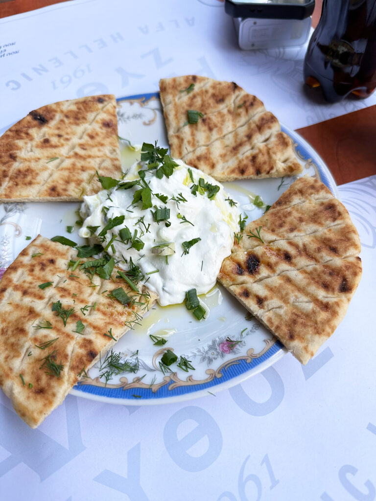 2 day in athens itinerary view of 4 pieces of pita bread with greek yogurt on plate