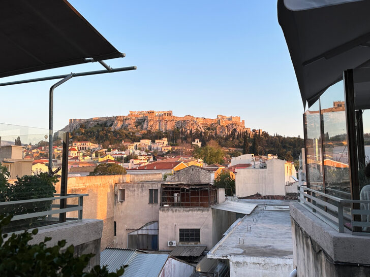 viewing the acropolis from a rooftop restaurant at dusk during two days in athens itinerary