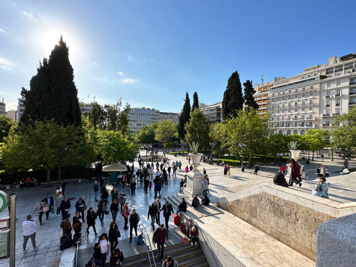 view of Syntagma Square with lots of people buildings and trees during 2 days in athens