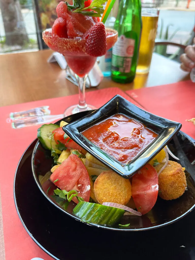 greek food falafels fresh veggies sauce with fruity drink