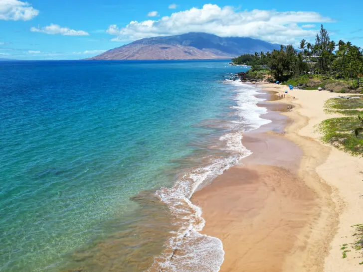 things to do in Kihei Maui view of beach with blue ocean and white waves with land in distance