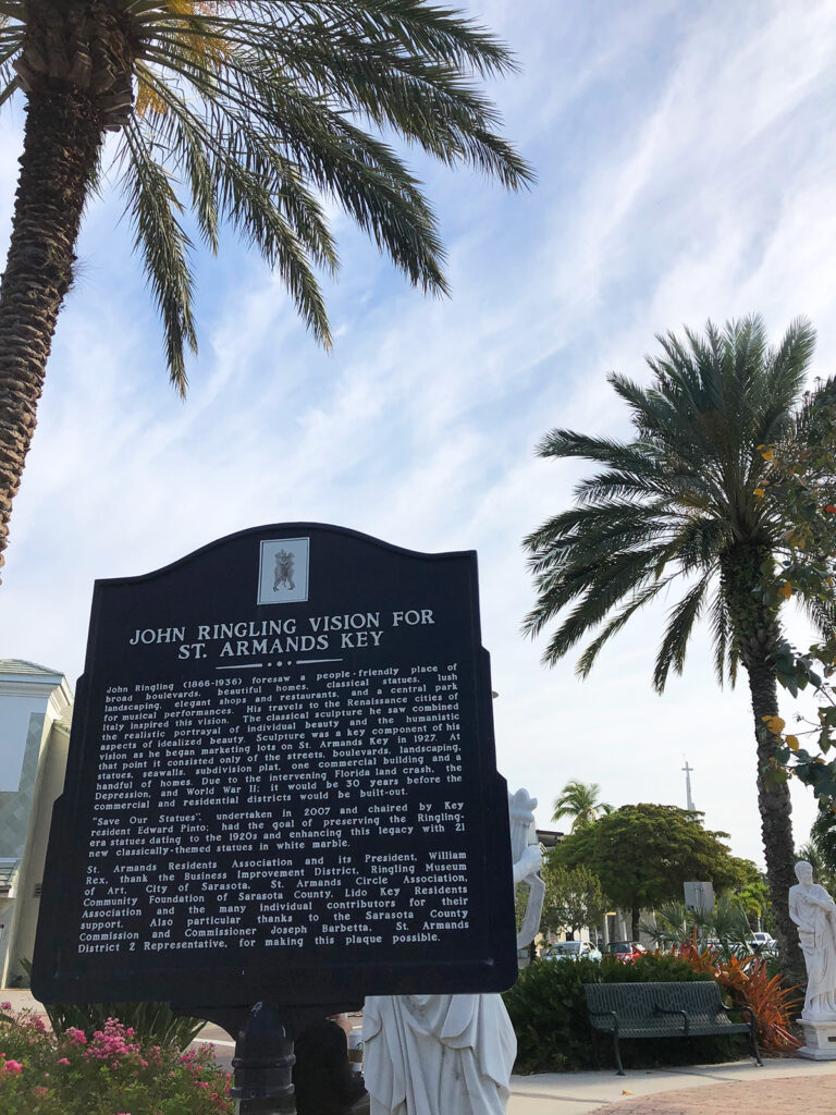 sign describing John Ringling vision for St Armands Key in detail with palm trees