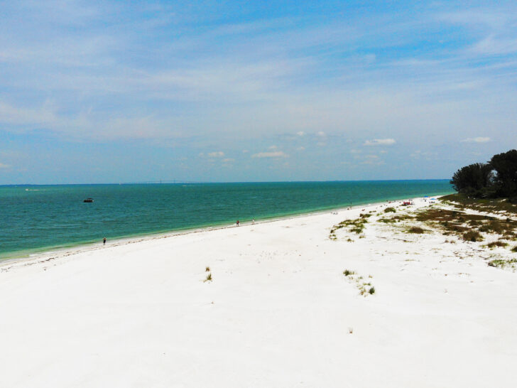 things to do in Anna Maria Island Florida view of white sand beach with green teal water in distance and blue sky