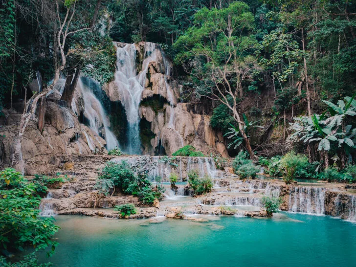 stunning waterfall scene in the jungle with teal water in Laos best countries to visit in February 