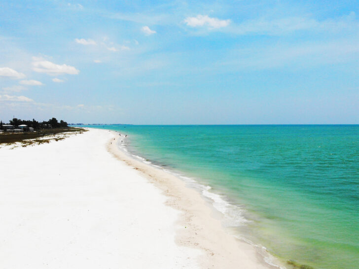 things to do in Anna Maria Island view of white sand beach with teal water and blue sky