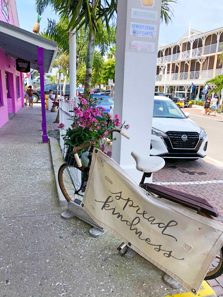 Anna Maria island gift shop with bike out front that reads spread kindness