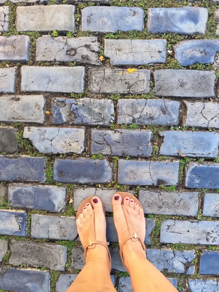 legs and feet standing on blue cobblestone things to do in Old San Juan