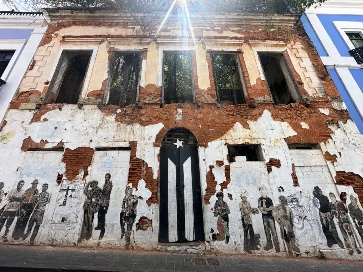 things to do in Old San Juan black and white door with mural on side of building in disrepair