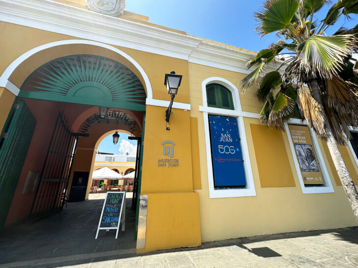 entrance to San Juan museum with yellow paint and palm tree best activities in old San Juan