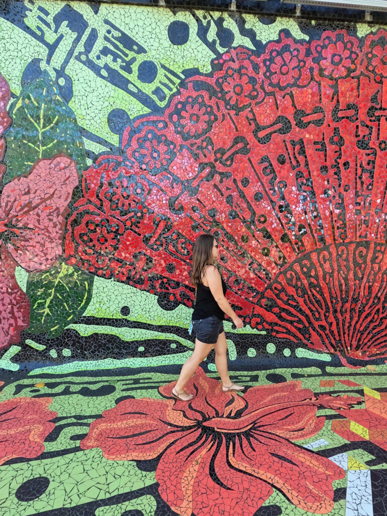 woman walking on colorful mural in San Juan PR