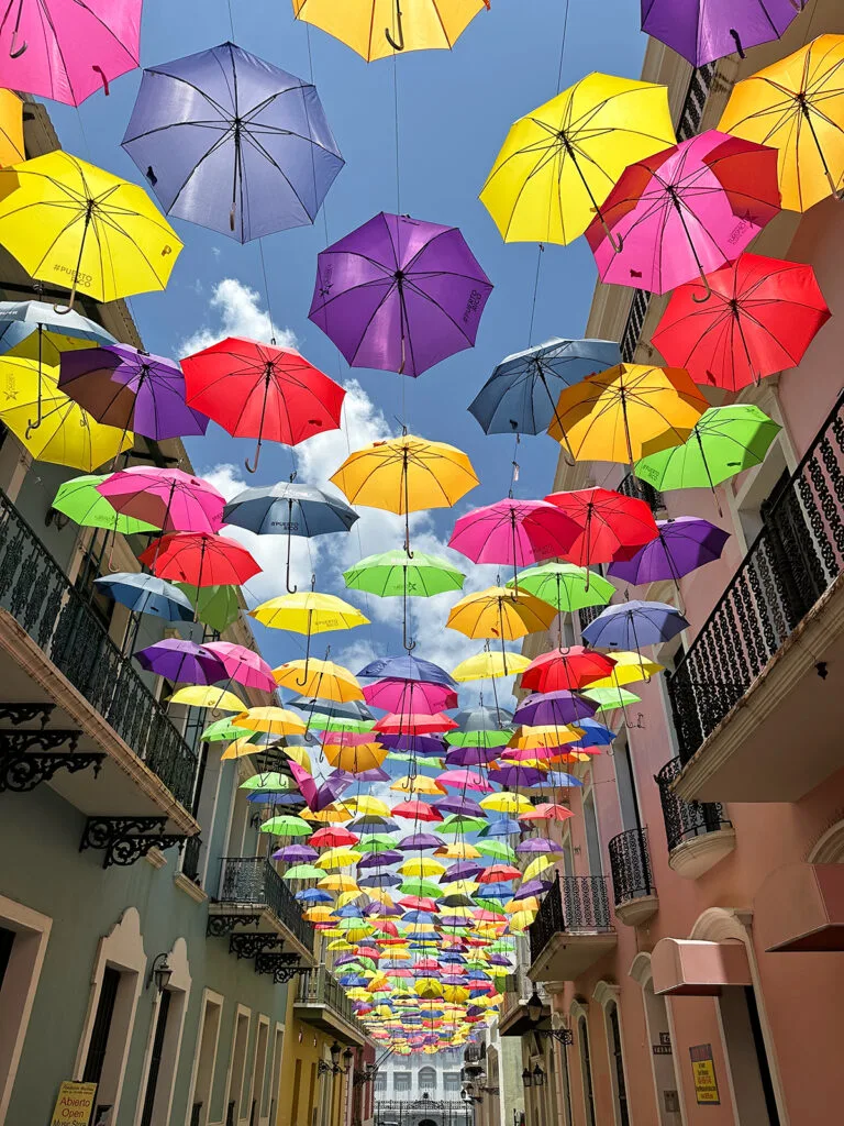 old San Juan colorful umbrella street with umbrellas hanging above street between buildings