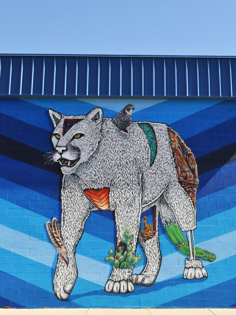 view of mural with large cat on blue stripes