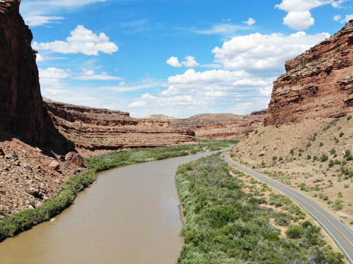 Colorado river through canyon next to road things to do in Moab like rafting