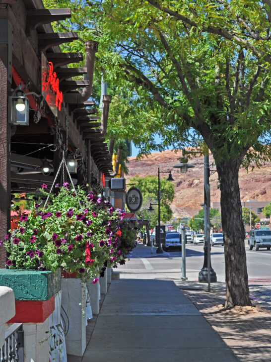 downtown streets of Moab Utah with view of flowers trees and sidewalk Moab attractions