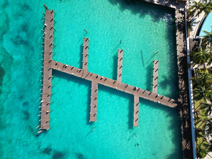 picture of wooden pier and teal water in Nassau while obeying Bahamas drone laws