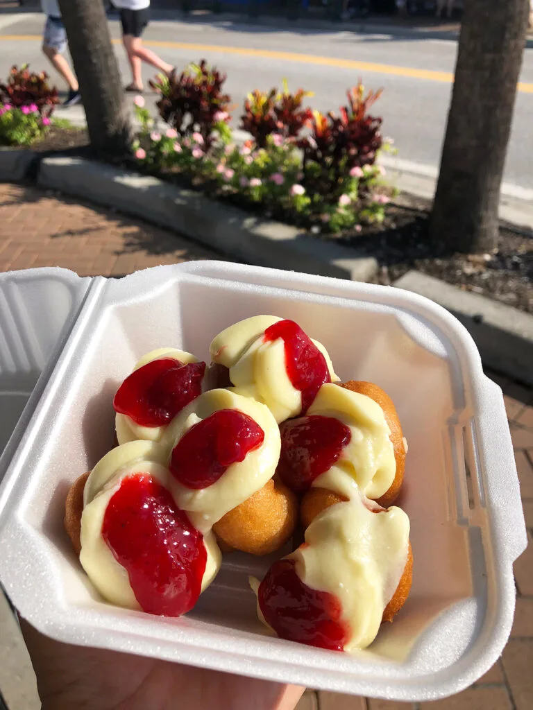things to do in Siesta Key visiting Meaney's Donuts with cream and strawberry filling