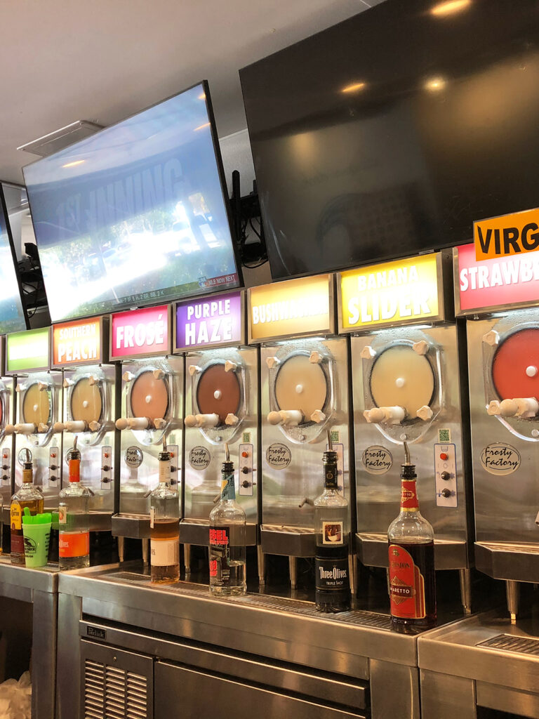line of frozen cocktail machines with names above them top restaurants in Siesta Key