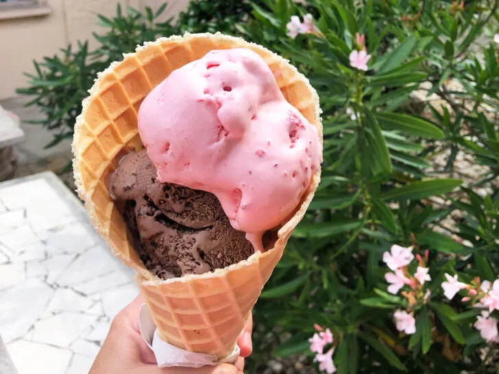 hand holding ice cream cone with strawberry on top of chocolate best things to do in Siesta Key