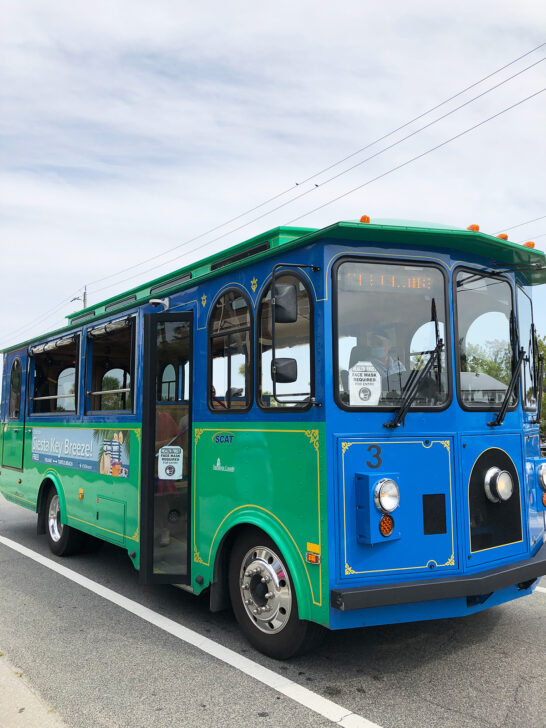 Siesta Key Trolley view of green and blue trolley on road