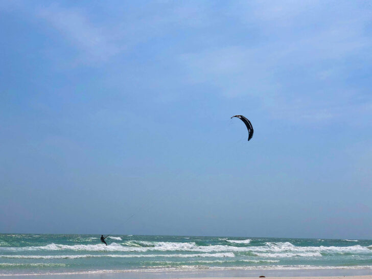 things to do in Siesta Key like kiteboarding with view of person on kiteboard on the water