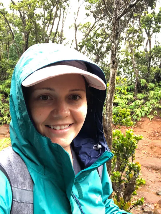 woman wearing hat and jacket on hiking trail