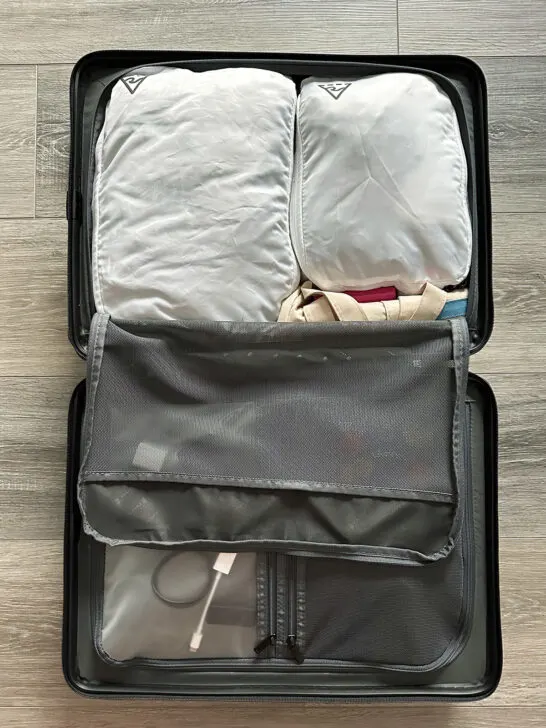 white packing cubes with suitcase open level 8 suitcases