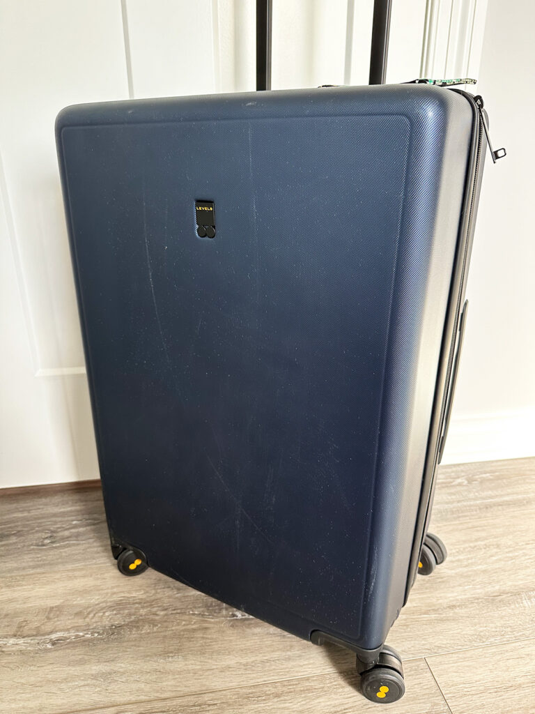 scratched level8 suitcase in navy