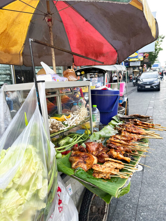 meat on skewers on street food cart in Khao san road Bangkok