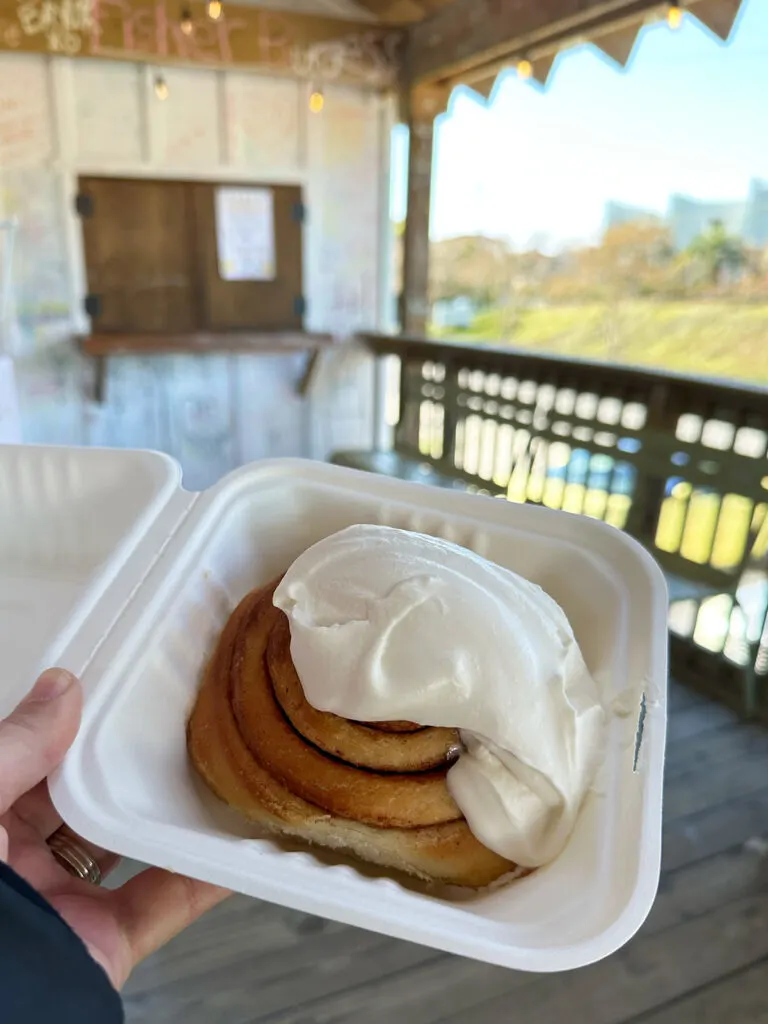 cinnamon roll with icing in container