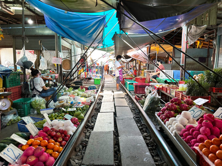 Maeklong station railway in thailand near Bangkok with fruit and vendors along tracks