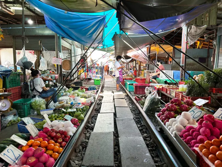 Maeklong station railway in thailand near Bangkok with fruit and vendors along tracks