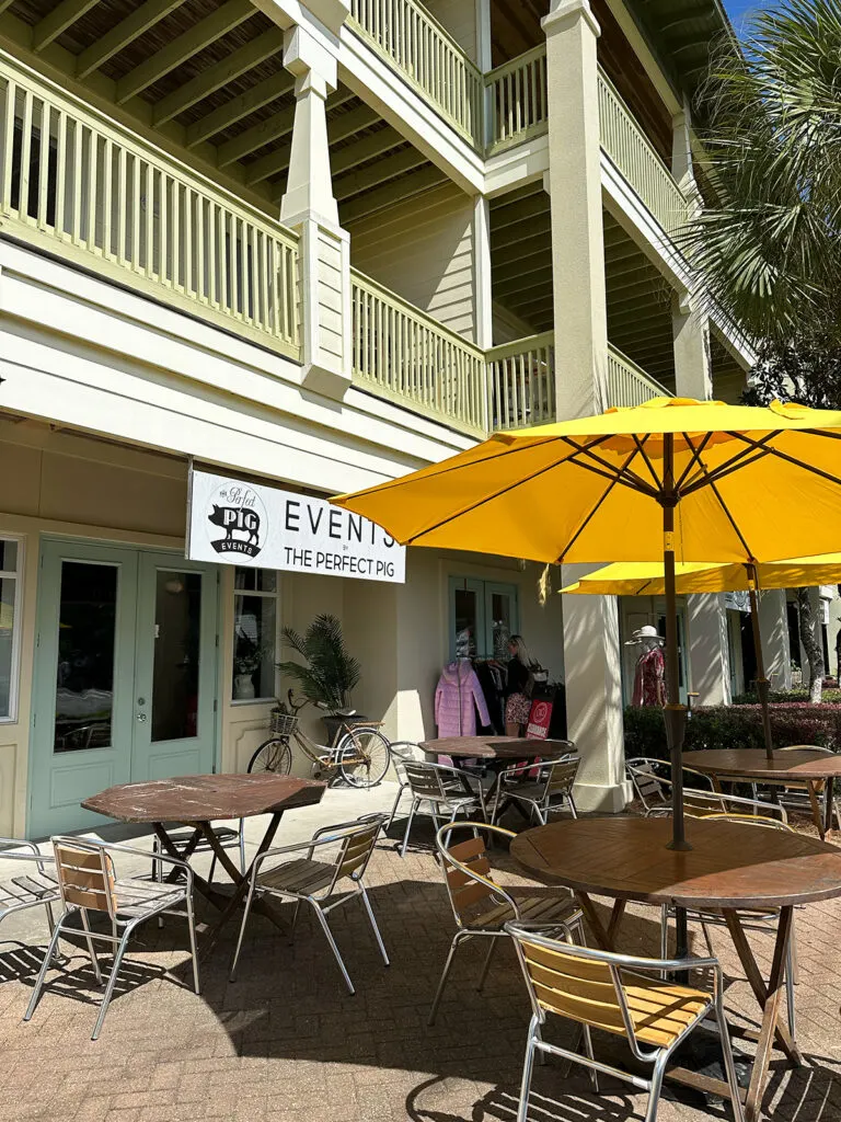 yellow umbrella and table and chairs in front of restaurant